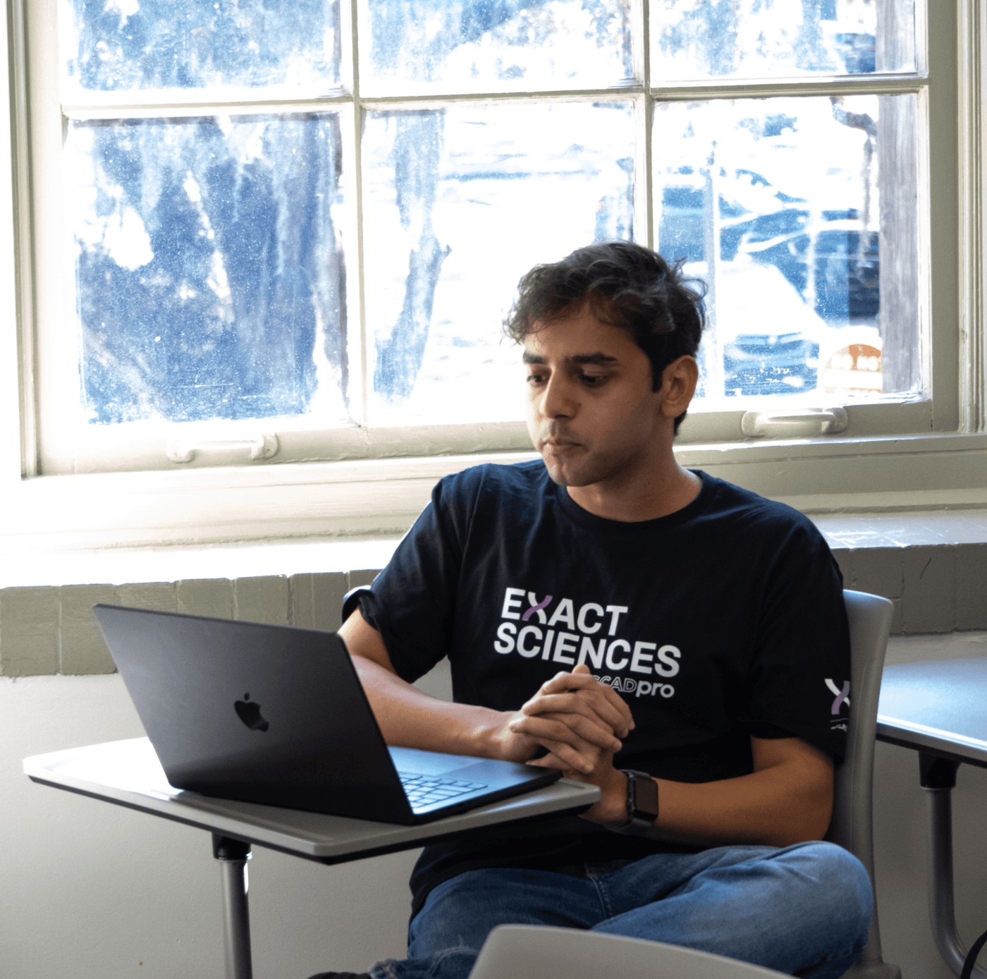 Aman Laliwala working at his desk during a SCADpro project